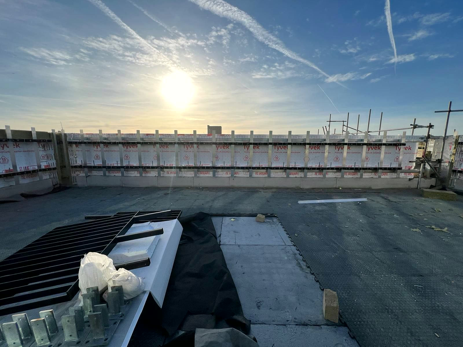 Roof-level facade with barriers installed, early morning