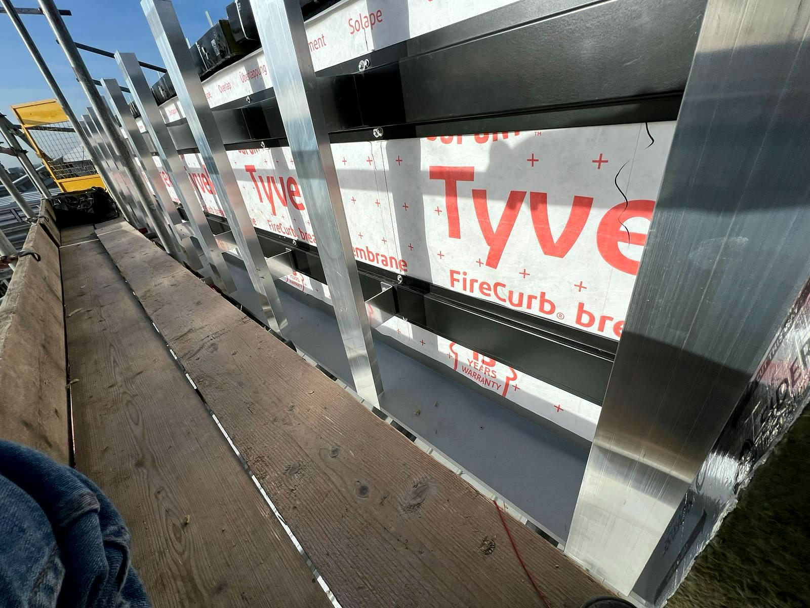 Cladding rails over FireCurb breather membrane with cavity barriers behind