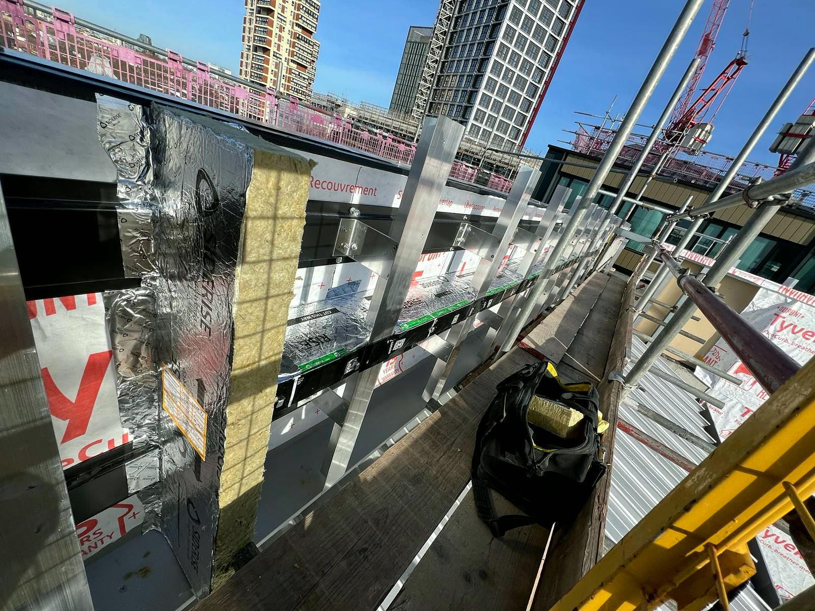 Foil-faced cavity barriers on a high-rise facade, scaffold level