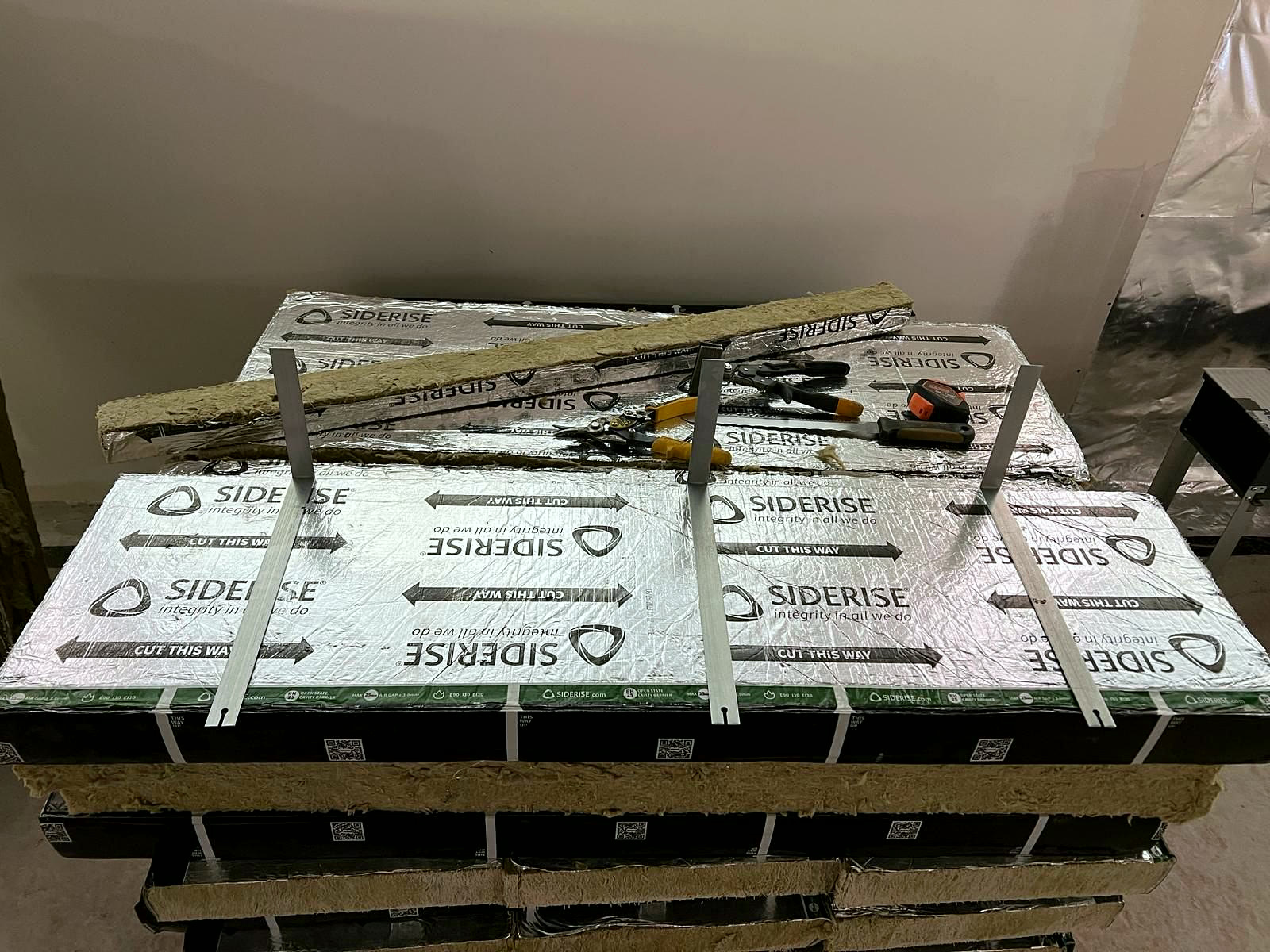 Stack of cavity barriers with brackets ready for installation