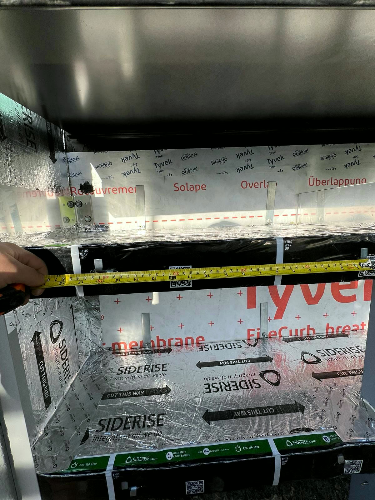 Cavity width measured with a tape before the barrier is fitted